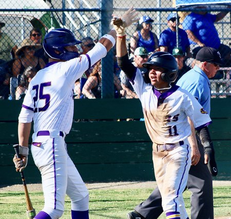 Lemoore's Chris Garcia gets a high-five from teammate Andrew Mora after scoring in the fifth inning.
